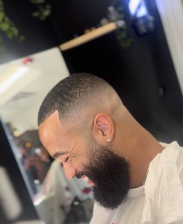 Close-up of a bald fade haircut with beard shape-up, done by Clipper Cole barber in Charlotte, NC