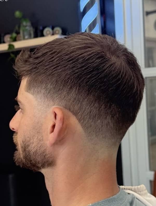 Low taper fade haircut with clean beard line, done by Clipper Cole barber in Charlotte, NC